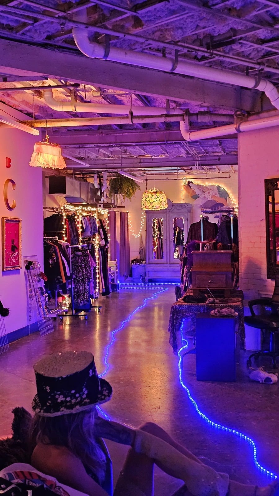 The original Closetorium fashion library, with clothing racks and purple lighting